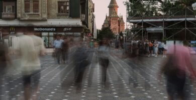 a blurry photo of people walking down a street